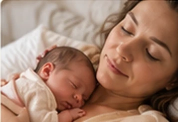 Mother cuddling her sleeping newborn